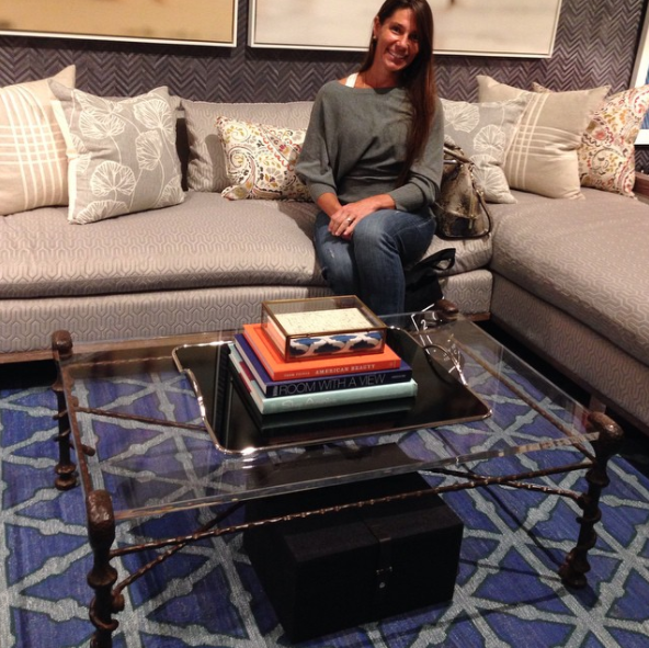 photo of heather karlie vieira of hkfa in the new york city showroom of thom filicia featuring a coffee table sourced by hkfa