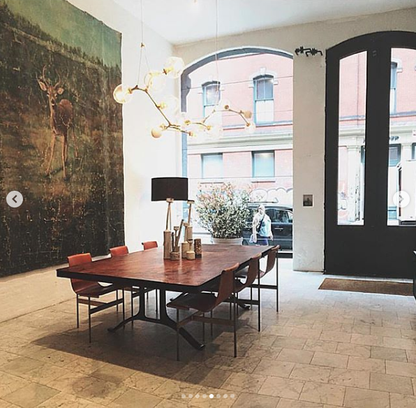 photo of the New York City showroom of BDDW by Tyler Hays featuring an antique hand painted wall mural on canvas sourced by Heather Karlie Vieira of HKFA