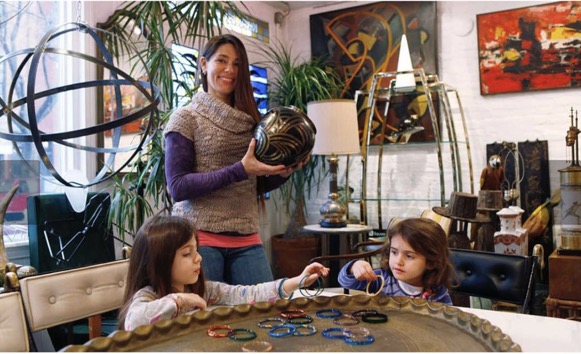 photo of heather karlie vieira of hkfa by michael s. wirtz for the philadelphia inquirer featuring heather and her two daughters surrounded by a collection of art, paintings, sculpture, antiques, furniture and decorative pieces