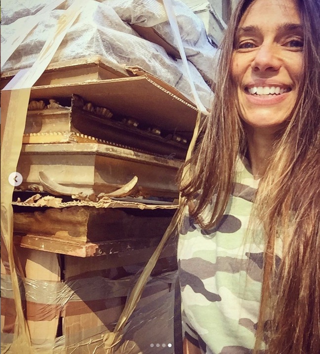 heather karlie vieira of hkfa with a huge pile of antique frames in a box on a dolly